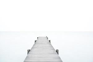 Wooden Dock Leading to a Hazy Horizon photo