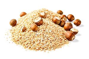 Close up of hazelnuts and hazelnut shells on a white background photo