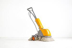 Yellow and Gray Floor Cleaning Machine on White Background photo