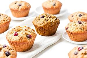 Close up of freshly baked cranberry muffins on white background photo