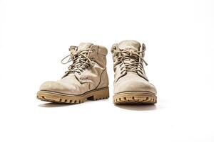 Pair of beige work boots on white background photo
