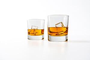 Two glasses of whiskey with ice on a white background photo