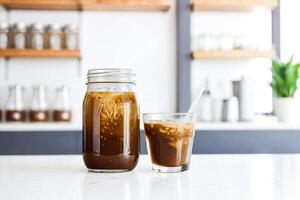 Iced Coffee in a Mason Jar on a White Table photo