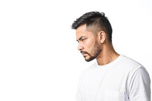 Young man looking down with serious expression photo
