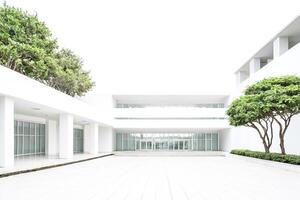 Modern White Building With Large Windows and Green Trees photo