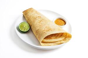 Dosa with chutney and lime wedge photo