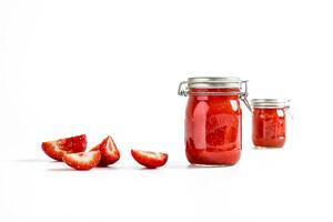 Homemade Strawberry Jam in Jars with Fresh Sliced Strawberries photo