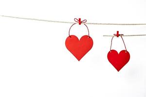 Two Red Hearts Hanging on a String photo