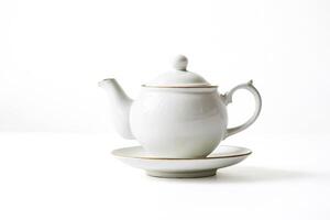 White Porcelain Teapot with Saucer on White Background photo