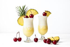 Two Pina Coladas with Pineapple Slices and Cherries on White Background photo