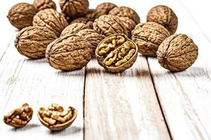 Walnuts on rustic wooden table photo