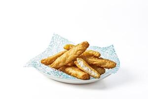 Crispy Fried Fish Sticks on a Plate with Blue and White Patterned Paper photo