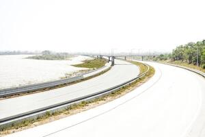 Empty highway with bridge in the background photo