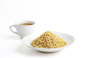 Close up of a bowl of instant noodles and a cup of coffee on a white background photo