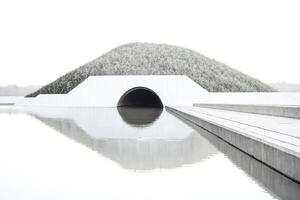 Minimalist Concrete Architecture with Tunnel and Water Reflection photo