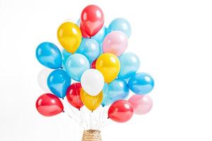 Bunch of colorful balloons tied together with strings photo