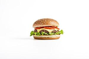 Close-up of a Delicious Cheeseburger with Lettuce and Tomato on a White Background photo