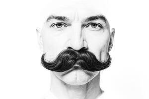 Closeup of a man with a mustache looking straight into the camera photo