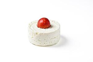 Round cheese with a red apple on top photo