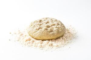 Closeup of a ball of dough on a bed of flour photo