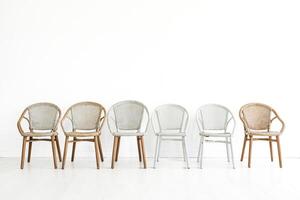 Five Empty Wicker Chairs in a Minimalist Room photo