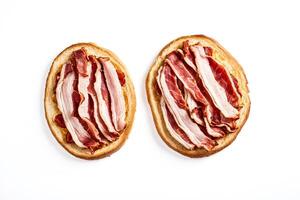 Two Toasted Bread Slices with Bacon Isolated on White Background photo