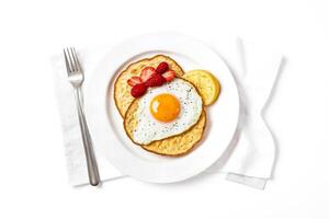 Fried egg on toast with strawberries and lemon photo