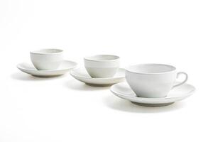 Three White Coffee Cups and Saucers on a White Background photo