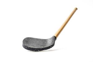 Black and wooden ladle on white background photo