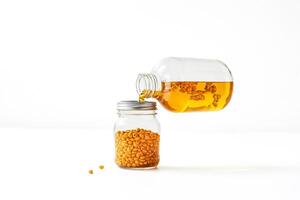 Golden Seeds Being Poured Into a Jar photo