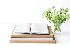 Open Notebook with Flowers on a White Table photo