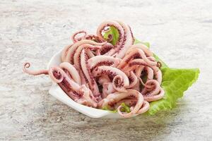 Marinated squid tentacles in the bowl photo