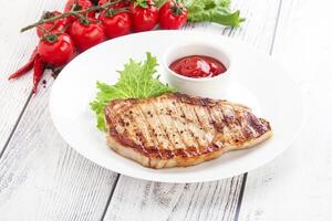 Grilled pork steak with ketchup photo