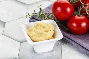 Dijon mustard sauce in the bowl photo