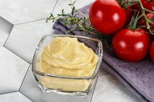 Dijon mustard sauce in the bowl photo