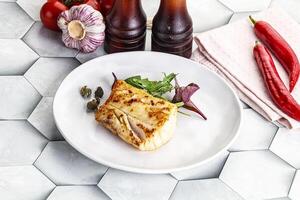 Roasted cod fish steak with salad photo