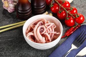 Delicous marinated squid tentacles in the bowl photo