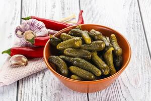 Marinated small cucumbers in the bowl photo