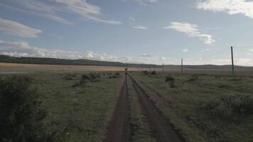 4wd vehicles drives on gravel road in flat surface road aerial view video