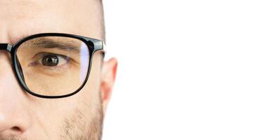 Banner. The eyes of a young man with glasses. Close-up. Copy space. photo