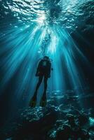 diver underwater, silhouette and sun light. photo