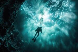 diver underwater, silhouette and sun light. photo