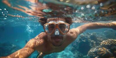 handsome man snorkeling underwater. photo