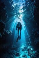 diver underwater, silhouette and sun light. photo