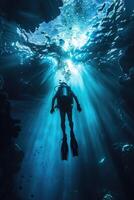 diver underwater, silhouette and sun light. photo