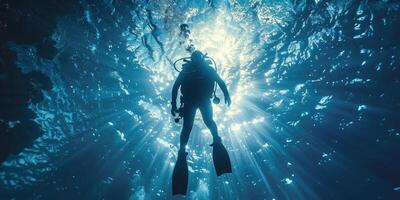 diver underwater, silhouette and sun light. photo