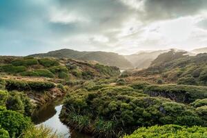 Sunrise shining over tropical rainforest with river in wilderness photo