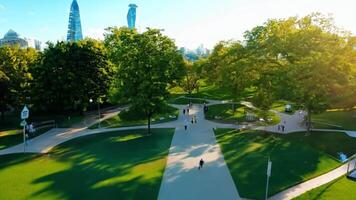 A sprawling urban park with walking paths, trees, and ponds. Bright, natural lighting to enhance the greenery. video