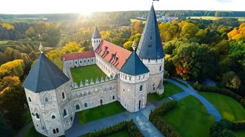Aerial shot A historic castle surrounded by lush gardens and greenery. Bright, natural lighting to create a fairytale-like setting. video