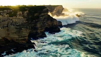 Aerial shot A dramatic coastline with rugged cliffs and crashing waves. Bright, natural lighting to highlight the dramatic scenery video